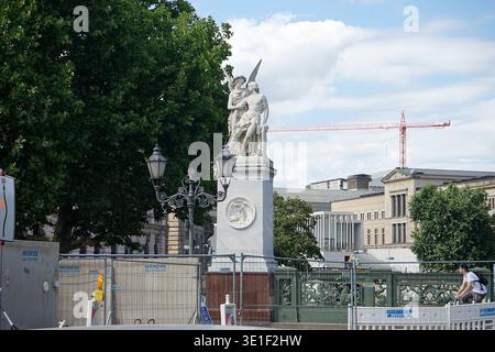 White marble warrior statues on Schlossbrücke with Berlin Cathedral dome, street lamps and urban surroundings, Mitte, Berlin, Germany, July 2018. Stock Photo