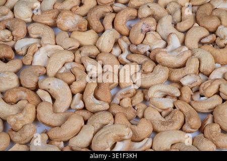 Nutty snack mood. Healthy salted cashews present cozy warmth. Mixture of salted cashew nuts spread out creates wholesome and soothing snacking experie Stock Photo