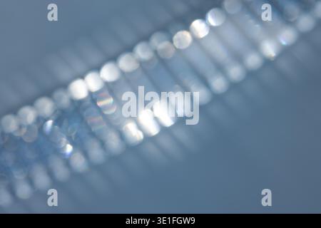 Defocused blue abstract background with shimmering reflective highlights and a soft luminous pattern. Ideal for modern design, technology visuals, lux Stock Photo