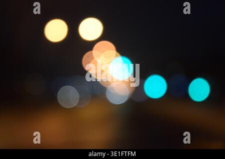 beautiful cloudy background of the night road with scattered sideways from the traffic lights of the night city. High quality photo Stock Photo