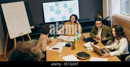 Group Strategizing Collaboratively, Collaborative Team Reviewing Project Timelines And Presentation Charts Stock Photo