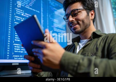 developer evaluates prototype happily today, technician reviews sample on screen with enthusiasm Stock Photo