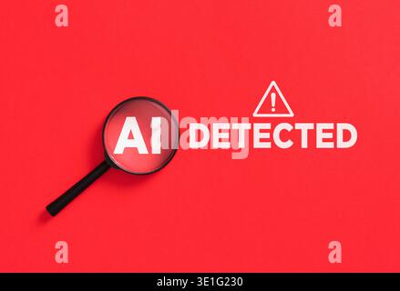 Magnifying glass highlighting AI text on a red background with DETECTED and an exclamation mark, symbolizing AI content detection Stock Photo