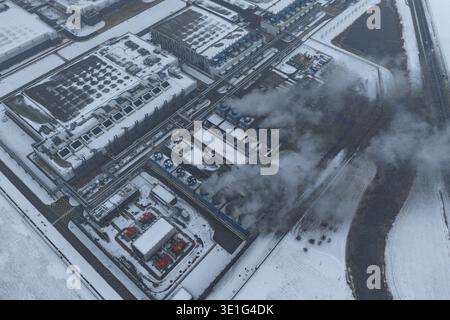 Aerial view of a large data center and industrial complex, operating in winter, showing cooling towers releasing steam, Eemshaven, Netherlands. Stock Photo
