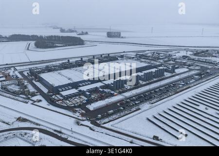 Aerial view of data center and solar farm operating in winter, representing cloud computing, global connectivity, and sustainable technology, Winschot Stock Photo