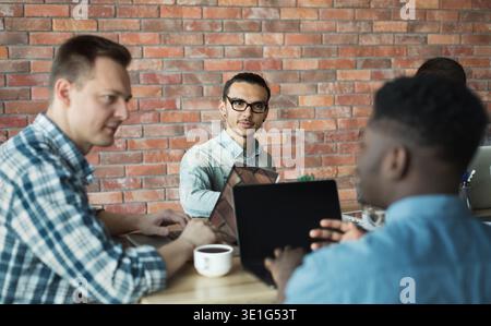 Software developers discussing marketing strategy ideas in office Stock Photo