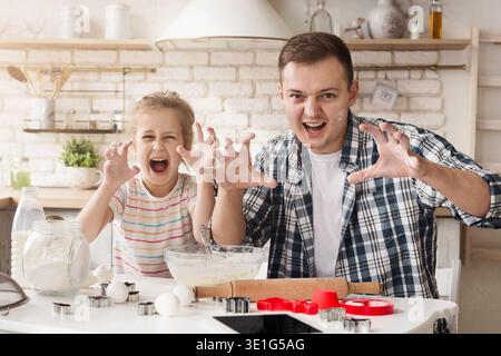 Father and daughter having fun while baking Stock Photo