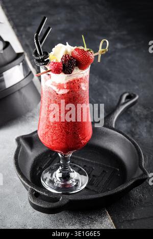 Frozen Berry Cocktail With Toppings. Chilled Mixed Berry Cocktail Served With Fruit And Cream Stock Photo