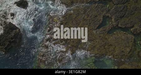 Rocky shoreline with deep blue green ocean Stock Photo