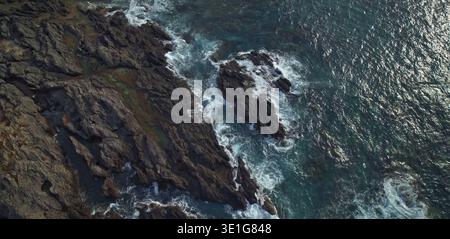 Rocky shoreline with deep blue green ocean Stock Photo