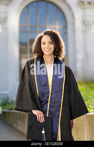 Proud Berkeley graduate holding cap and celebrating achievement Stock Photo
