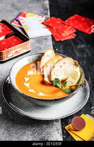 Silky Pumpkin Blend With Herbs On Bread. Vibrant Roasted Pumpkin Soup Served With Garnished Toast Stock Photo