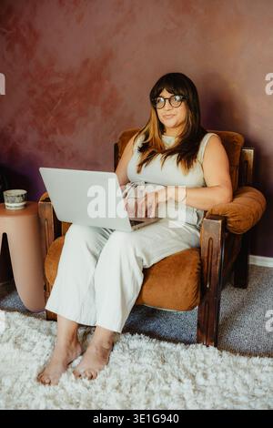 Woman working remotely from home office Stock Photo