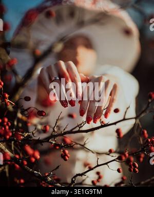Red polka dot manicure inspired by mushroom pattern in forest Stock Photo