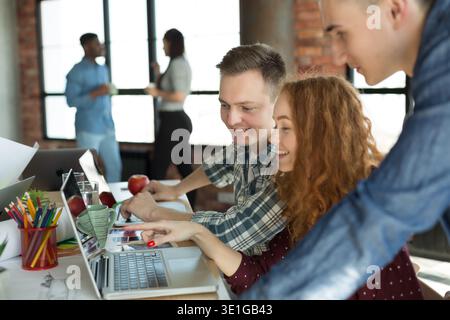 Young team of targeters working on project together Stock Photo