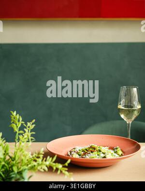 Chic Outdoor Meal With Greenery Ambiance. Sophisticated Midday Eating Scene With Wine And Plants Stock Photo