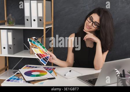 Young designer working with blueprints in the office Stock Photo