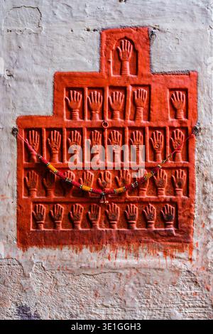 The Loha Pol in Jodhpur features numerous small handprints of royal widows, covered in red pigment and adorned with a garland. Stock Photo