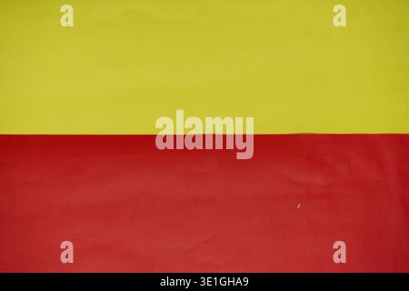 This vibrant background features a crisp horizontal split of bright yellow and rich red, creating a striking contrast. It's perfect for copy space, gr Stock Photo