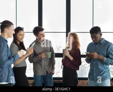 Male and female colleagues resting during break in office Stock Photo