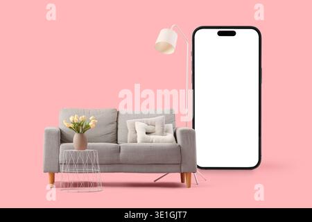 Comfortable sofa and mobile phone with blank screen on pink background Stock Photo