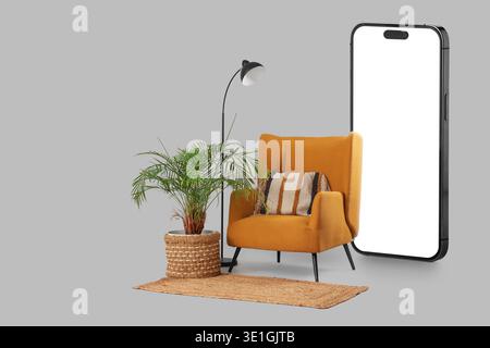 Comfortable armchair and mobile phone with blank screen on grey background Stock Photo