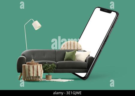 Comfortable sofa and mobile phone with blank screen on green background Stock Photo