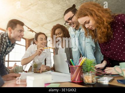 Group of young colleagues brainstorming in office Stock Photo