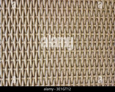 A full frame shot showcasing the intricate weave of natural rattan fibers, highlighting the texture and organic pattern of the material Stock Photo