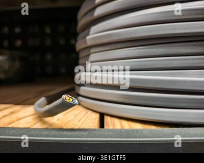 This image showcases a close view of neatly coiled electrical wire, highlighting its texture and colors Stock Photo