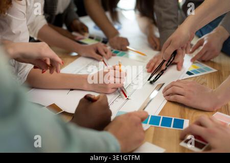 Team of architects working on construction plans Stock Photo