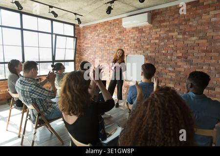 Applauding students congratulating their teacher after lesson Stock Photo