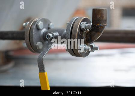 A hydraulic crane with flanges and bolts sticking out of the barrel. High quality photo Stock Photo