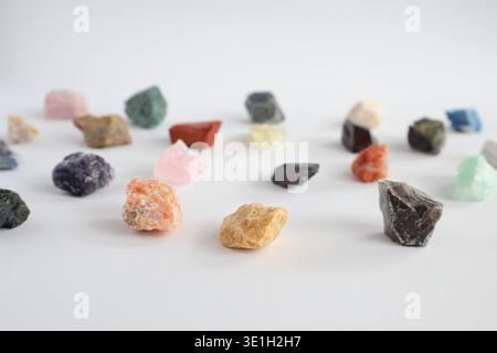 Collection of various raw colorful gemstones and minerals on a white background Stock Photo