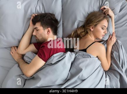 Top view of young couple sleeping in bed Stock Photo