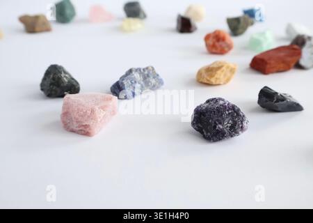 Collection of various raw colorful gemstones and minerals on a white background Stock Photo