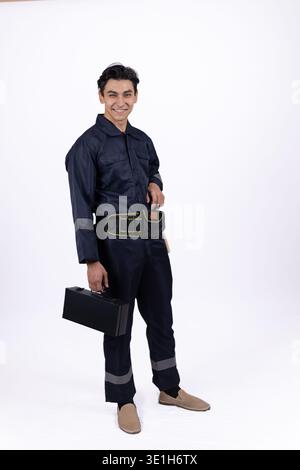 Young courier in uniform holding a black bag Stock Photo