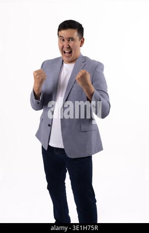 Energetic man showing muscles and celebrating Stock Photo