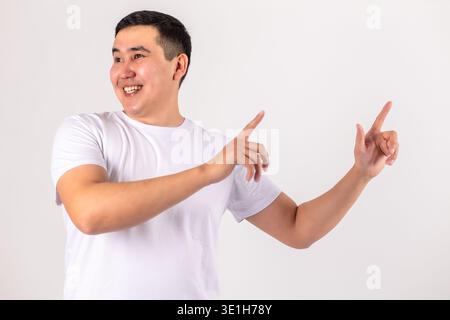 Happy man pointing with both hands to the side Stock Photo