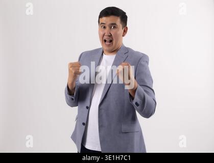 Happy man celebrating success with clenched fists Stock Photo