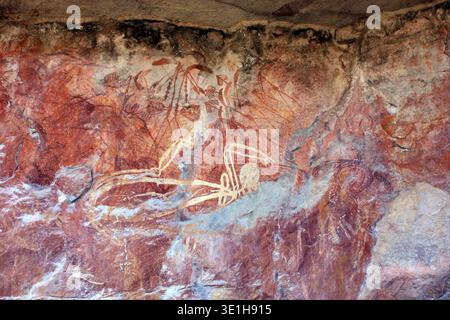 Aboriginal rock art depicts figures of Mimi Spirits on a cave wall ...