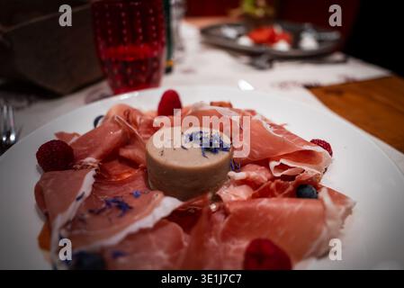 Italian alpine prosciutto and mousse with berries in San Domenico Stock Photo
