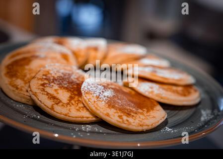 Ring of golden brown pancakes on grey plate in San Domenico, Italy Stock Photo