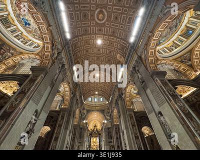 Upward gaze at Baldachin and dome’s geometric ceiling in St. Peters Basiclica. Rome, Italy. Stock Photo