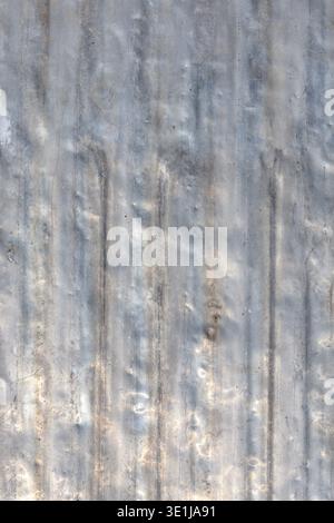 Rugged aluminum surface displays intricate texture with scratches and dents under bright daylight. Stock Photo