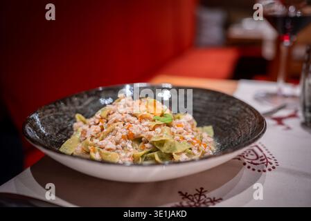 Gourmet tagliatelle with creamy ragu in San Domenico, Italian Alps Stock Photo