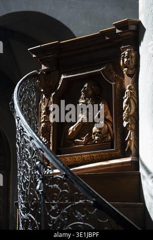 Detailed view of the artfully carved baroque wooden pulpit in Constance Cathedral, showing in dynamic perspective the relief-decorated stair railing a Stock Photo