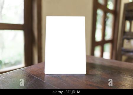 Menu mock up blank for text marketing promotion. Mock up Menu frame standing on wood table in restaurant space for text Stock Photo