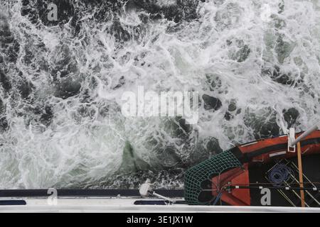 Big water splash seen from above a boat Stock Photo
