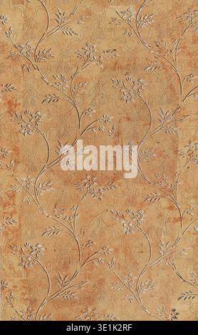 This antique sidewall wallpaper, likely from the early 1900s, features a charming botanical pattern with delicate branches and leaves in white and brown, set against a warm, distressed ochre background. The underlying dotted floral motif adds depth and texture to the vintage design. Stock Photo